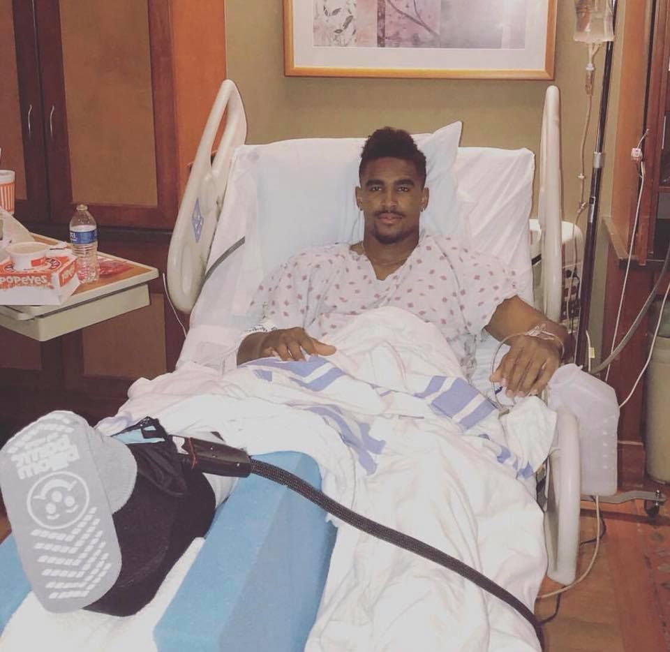 Jalen hurts sitting in a hospital bed recovering from an ankle surgery